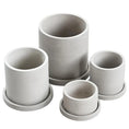 Load image into Gallery viewer, Four cylindrical cement concrete MINIMALIST FLOWER POTS from House of Effy, each with a matching saucer underneath, perfect for enhancing your garden or outdoor space.
