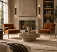 Load image into Gallery viewer, A styled living room featuring two rust-orange velvet armchairs with gold metal frames, arranged around a round stone coffee table in front of a fireplace.
