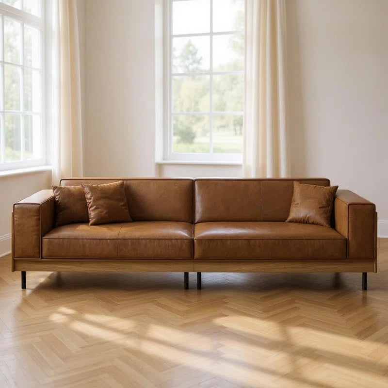 Leather 2-Cushion Sofa in Room With Windows and Drapes