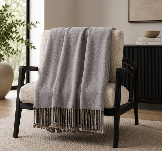 REVERSIBLE MULBERRY SILK THROW in living room draped over a chair sitting on an accent rug