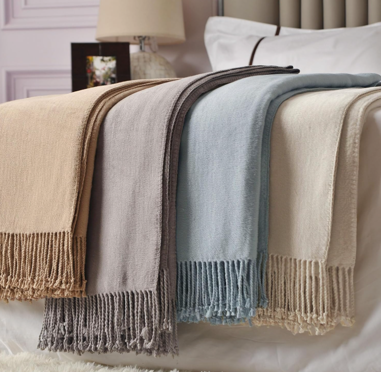 Silk Throw Blanket Ivory With Others Folded on a Bed