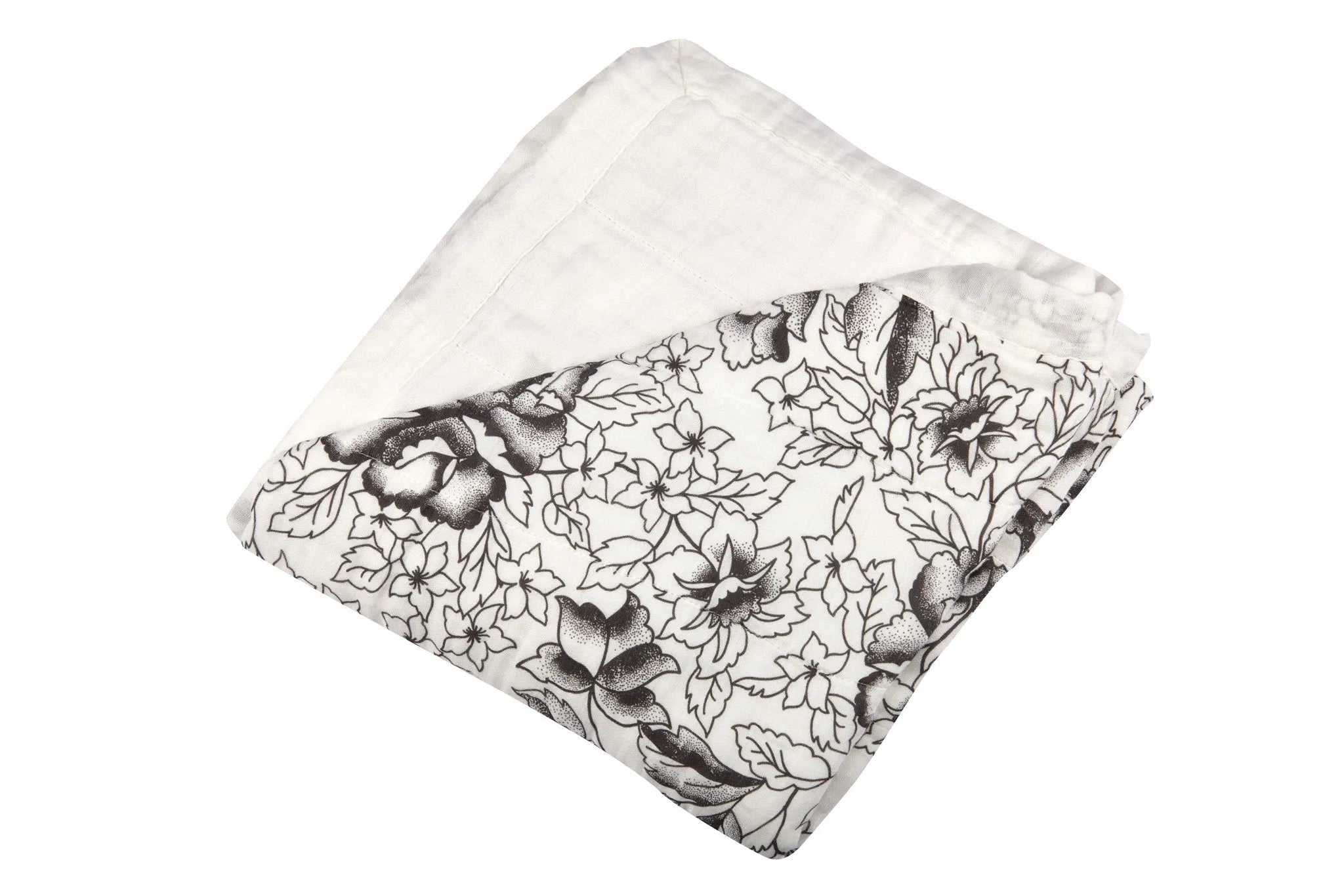 A folded piece of white fabric with a black floral pattern on one side, the luxurious House of Effy ROSE BLANKET adds a touch of elegance to any home décor.