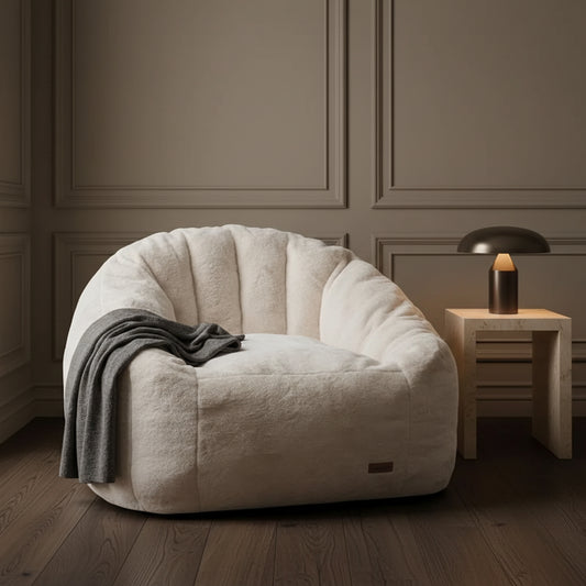 SOFA CHAIR IN ROOM WITH FAUX PLANT