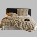 Load image into Gallery viewer, A neatly made bed with a black headboard, featuring a fluffy beige comforter and pillows, highlighted by a House of Effy TUSCAN THROW for extra winter warmth, with an open book and glasses placed on top.
