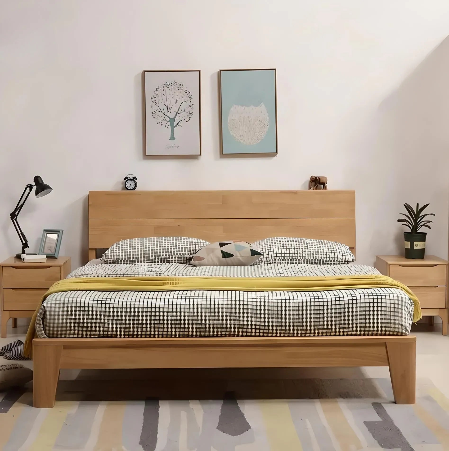 A modern bedroom luxury features a House of Effy QUEEN MINIMALIST BED with checkered bedding, flanked by two wooden nightstands with lamps and a potted plant. Minimalist design is enhanced by wall art hanging above the headboard.