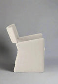 Load image into Gallery viewer, Side view of a luxurious, modern, geometric white CONTEMPORARY FABRIC DINING CHAIR by House of Effy with a high backrest set against a plain gray background.
