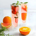 Load image into Gallery viewer, Two tall glasses of citrus-infused water with strawberry slices and mint leaves, accompanied by a whole orange and orange slices on a white surface, make a stunning addition to any drinkware collection. Featuring the elegant design of House of Effy's ESPRESSO SHOT GLASSES.
