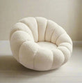 Load image into Gallery viewer, The PUMPKIN CHAIR by House of Effy, featuring a plush white, rounded form with a quilted puffy design, sits elegantly on a light wooden floor against a beige wall.
