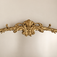 Load image into Gallery viewer, An ornate gold decorative mirror frame detail with baroque-style scrolling flourishes, shown against a plain light beige background.
