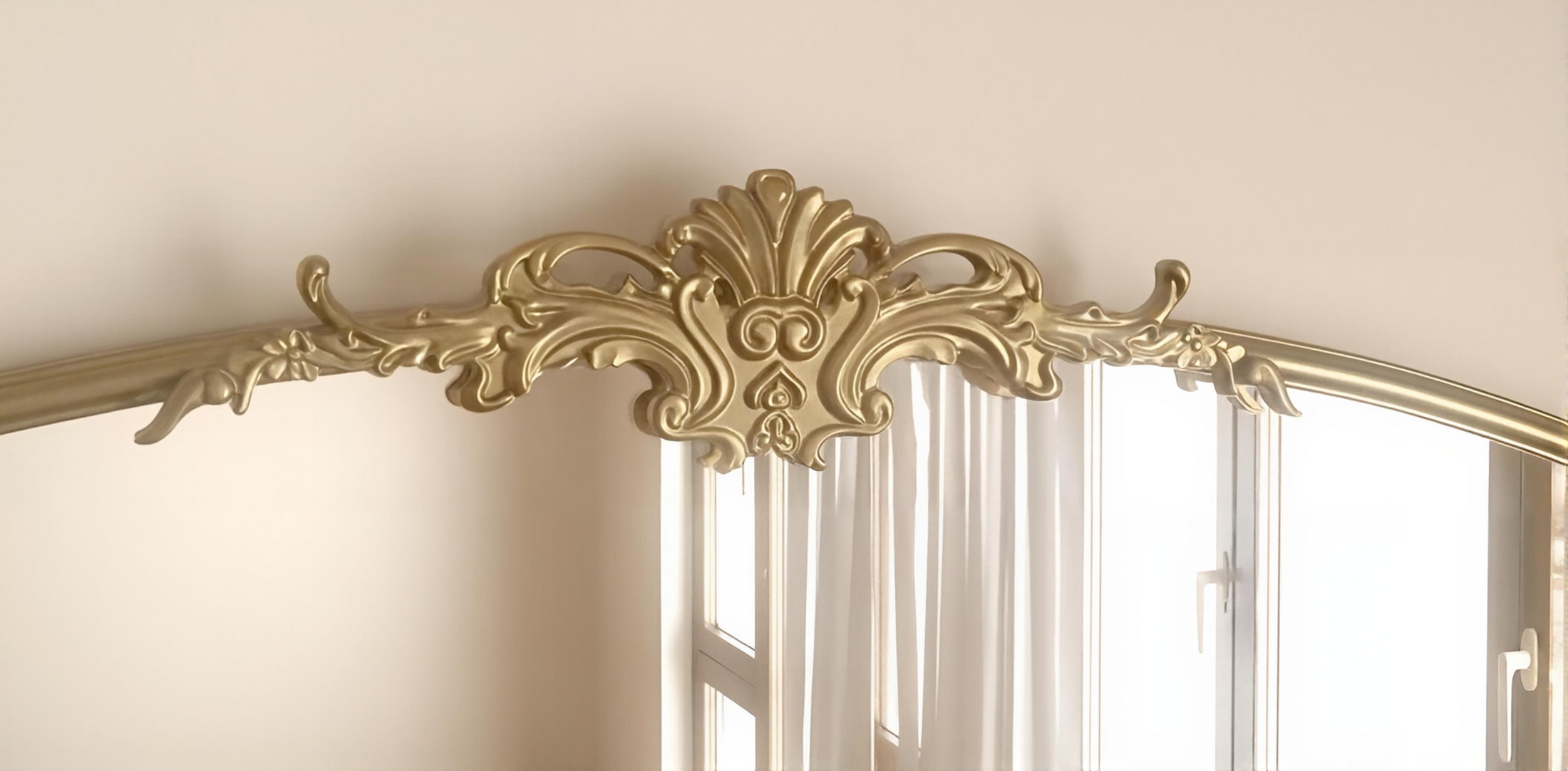 arched mirror gold on wall in a house