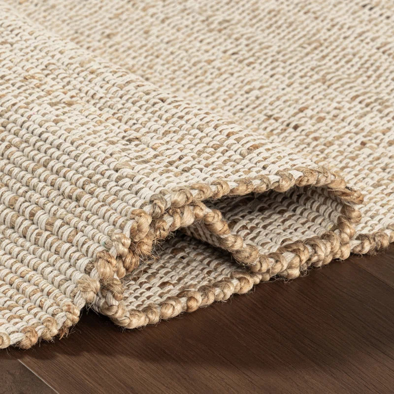 area rug close-up of it folded on hardwood floor
