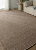 Load image into Gallery viewer, brown area rug in living room with sofa and side table
