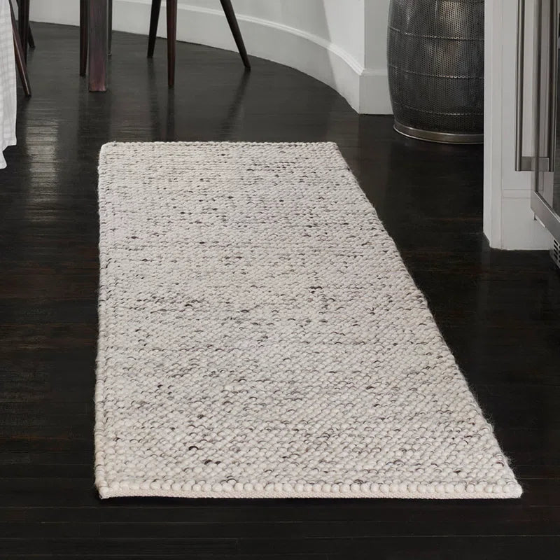 area rug on dark hardwood floor in room