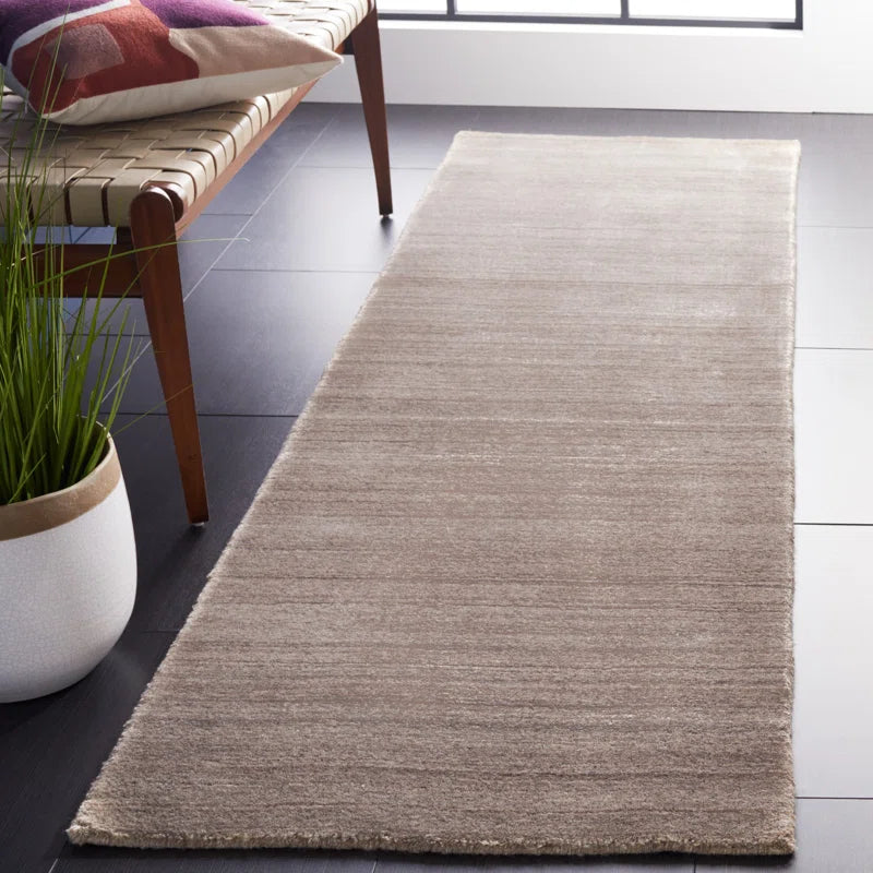 area rug runner on floor beside bench