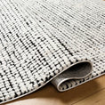 Load image into Gallery viewer, area rug folded over on hardwood floor
