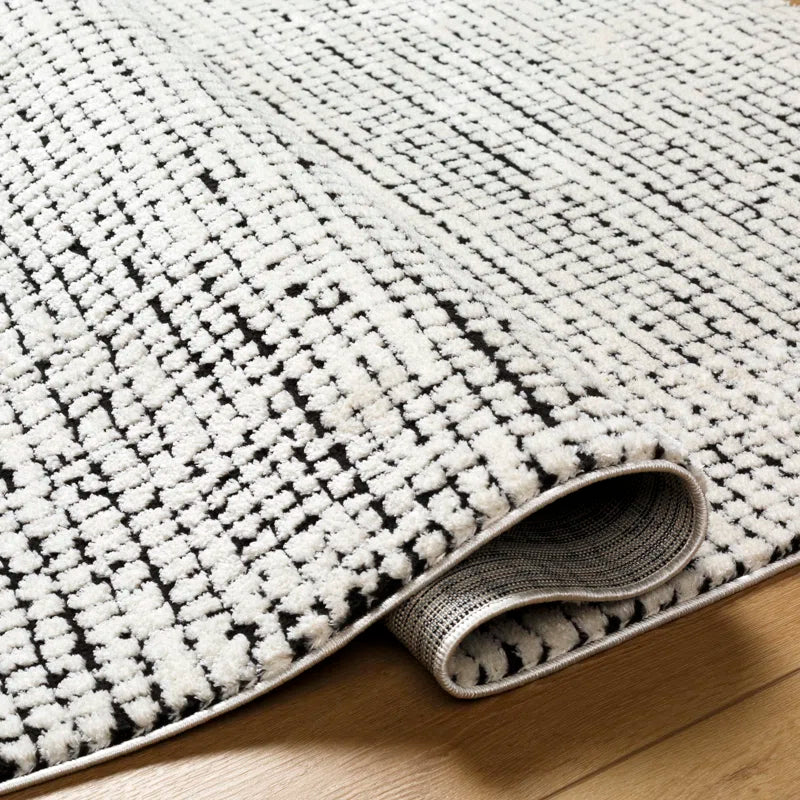 area rug folded over on hardwood floor