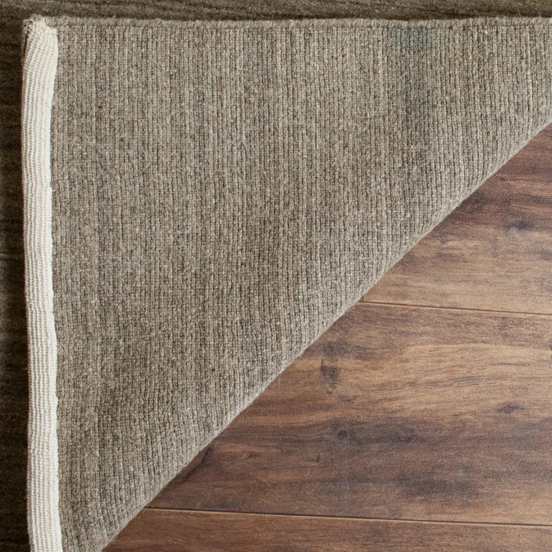 area rug with flipped corner on top of hardwood flooring