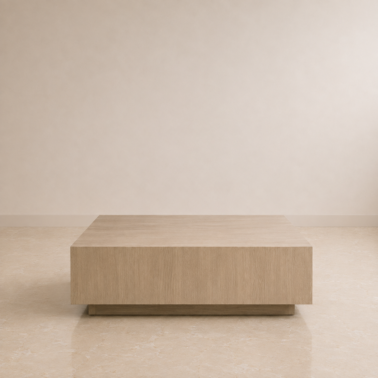 A low, rectangular coffee table with a light oak wood grain finish, positioned against a minimalist beige wall and tiled floor.