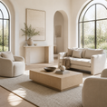 Load image into Gallery viewer, A bright, modern living room with neutral beige furniture, including a sofa, armchair, beige coffee table, and a large textured rug, styled with minimalist decor under arched windows.
