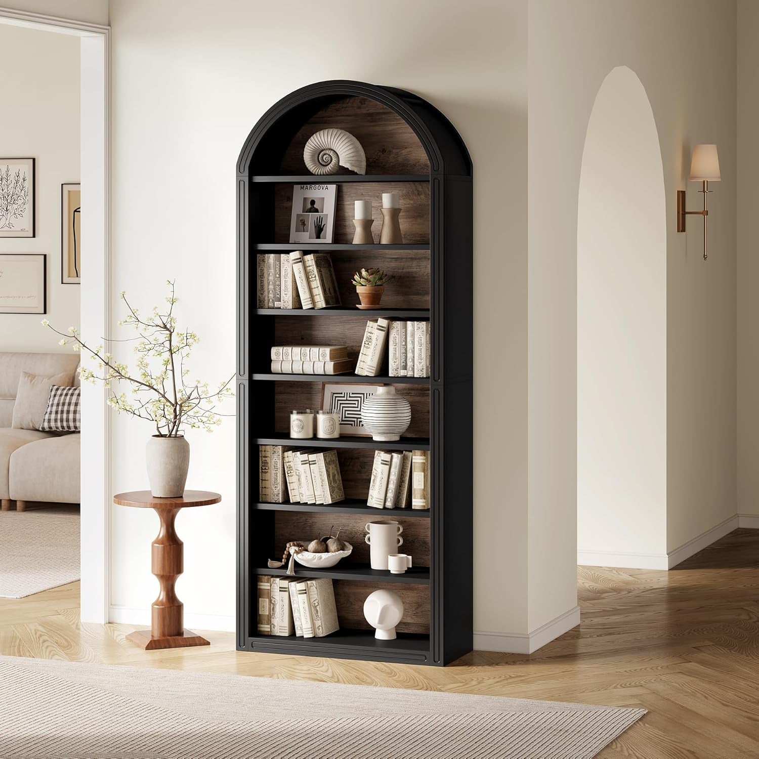 black arched bookcase with decor on it