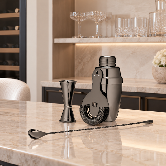 black barware set at in-home bar across from flowers and glasses