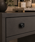 Load image into Gallery viewer, black crystal cabinet knob on drawer close up with decor on top of the vanity
