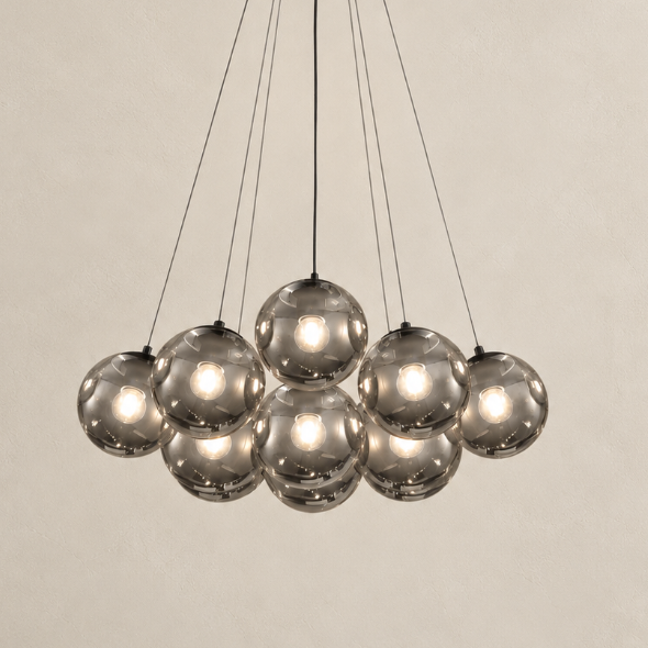 Black globe chandelier with smoked gray glass shades and suspended pendant lights against a neutral background