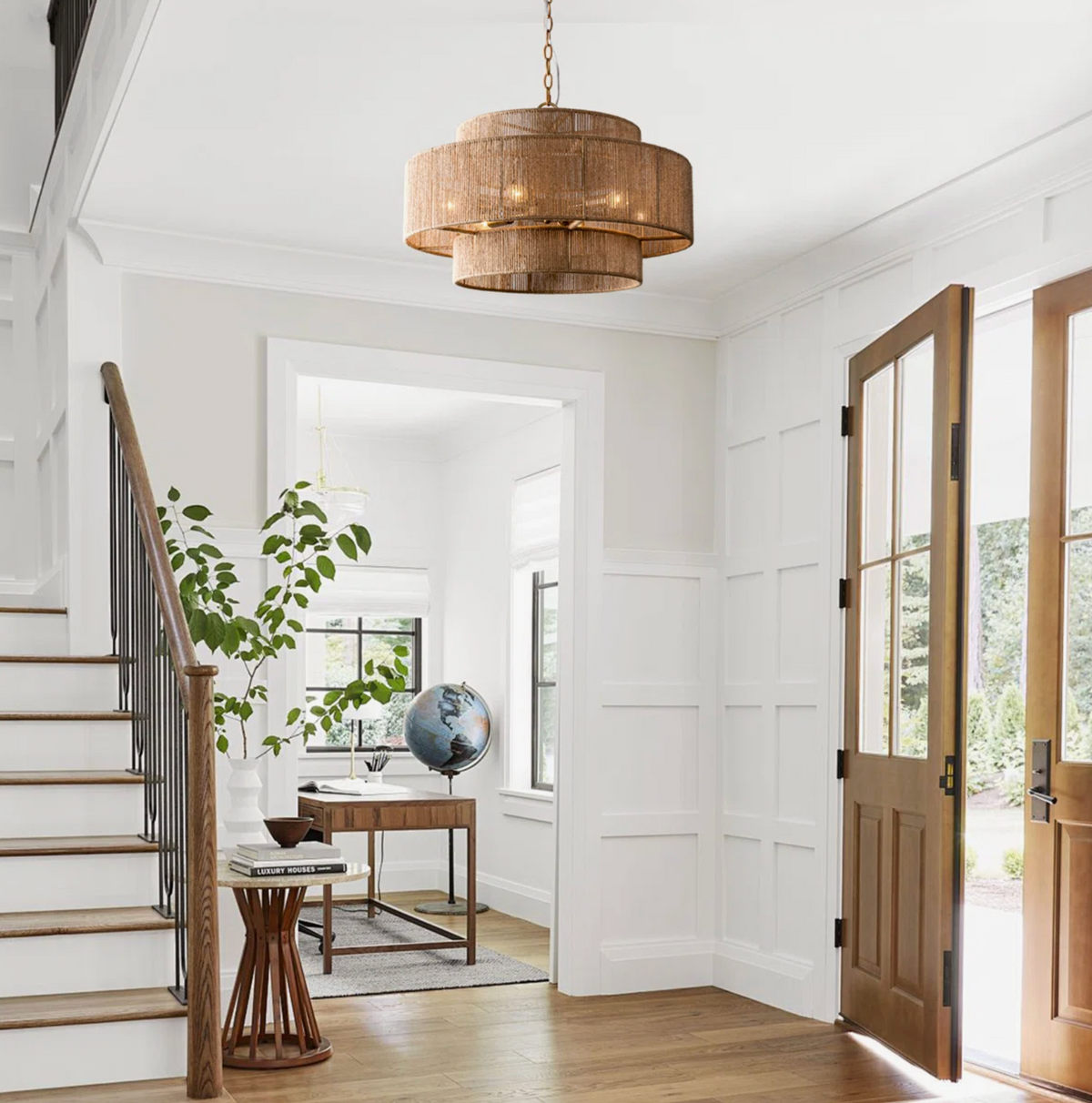 boho chandelier in foyer across from door and staircase