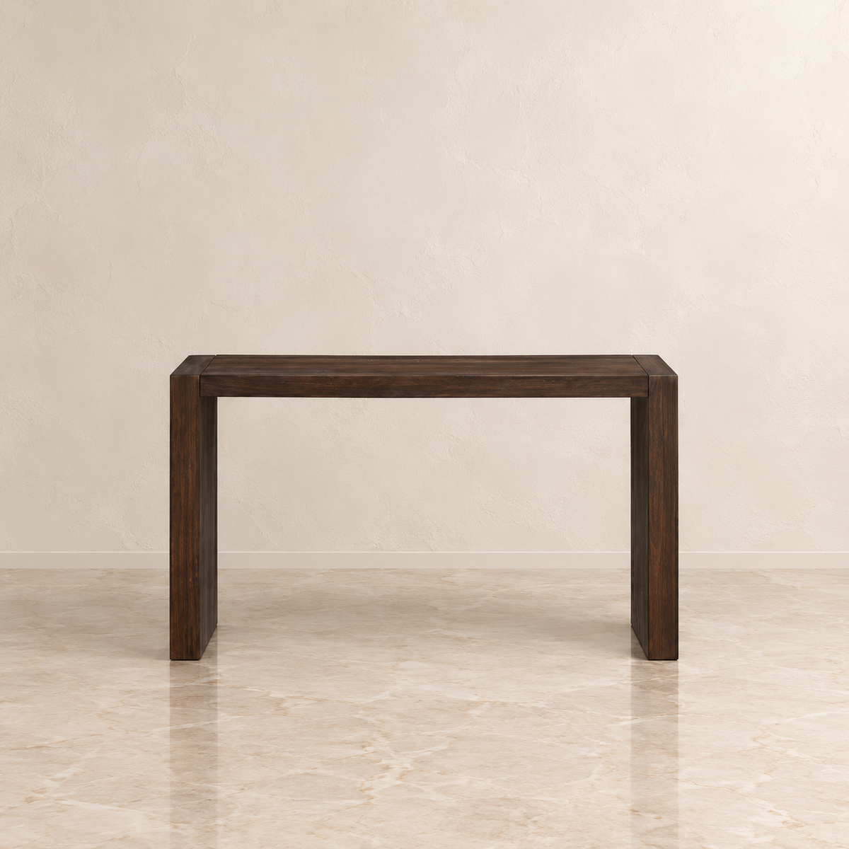 A dark brown wooden console table with a minimalist rectangular design, set against a neutral beige textured wall and marble floor.