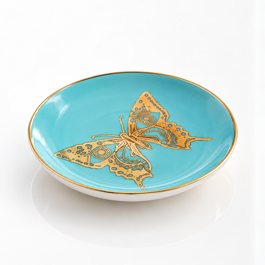 A turquoise butterfly coaster with a gold-rimmed edge and a large gold butterfly design in the center, shown on a clean white background.