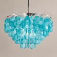 Load image into Gallery viewer, A modern chandelier featuring a circular silver metal frame adorned with numerous translucent, disc-like turquoise blue glass or acrylic pendants, suspended against a solid warm beige background.
