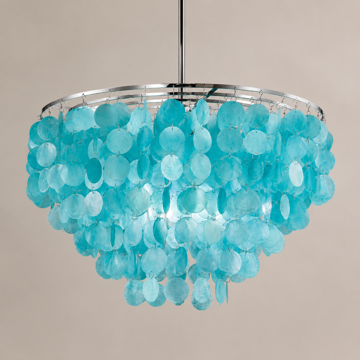 A modern chandelier featuring a circular silver metal frame adorned with numerous translucent, disc-like turquoise blue glass or acrylic pendants, suspended against a solid warm beige background.