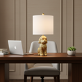 Load image into Gallery viewer, A dog lamp featuring a textured gold dog-shaped base and a white drum shade, shown against a plain white background.
