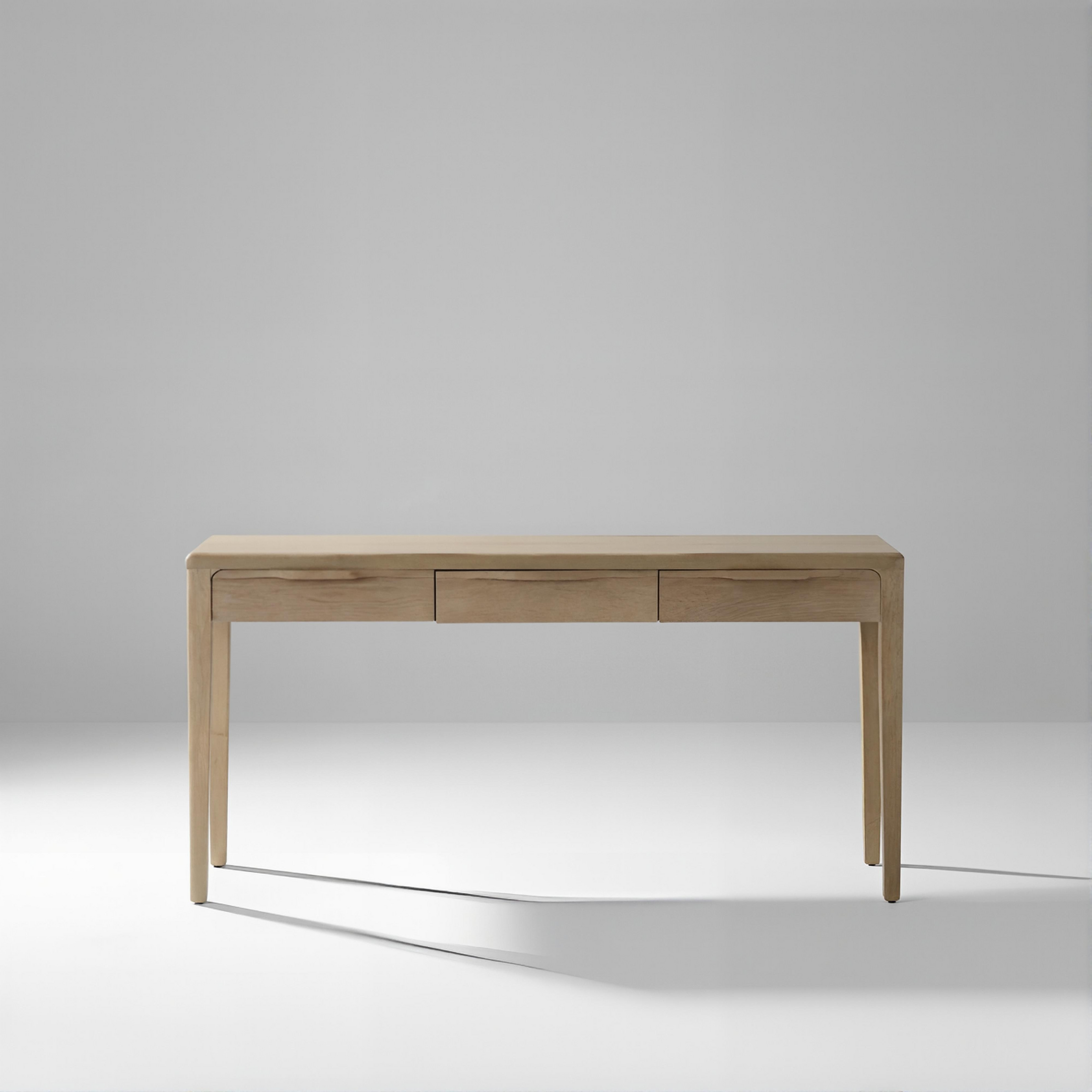 console table with three drawers in a light gray studio