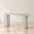 Load image into Gallery viewer, A modern light gray console table with a rectangular top and thick block legs, shown in a minimalist room setting with a beige wall and marble floor.
