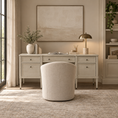 Load image into Gallery viewer, A styled home office scene featuring a light beige writing desk with six drawers, a matching upholstered barrel chair in front, a lit brass desk lamp, and a large abstract canvas painting hanging on the wall.
