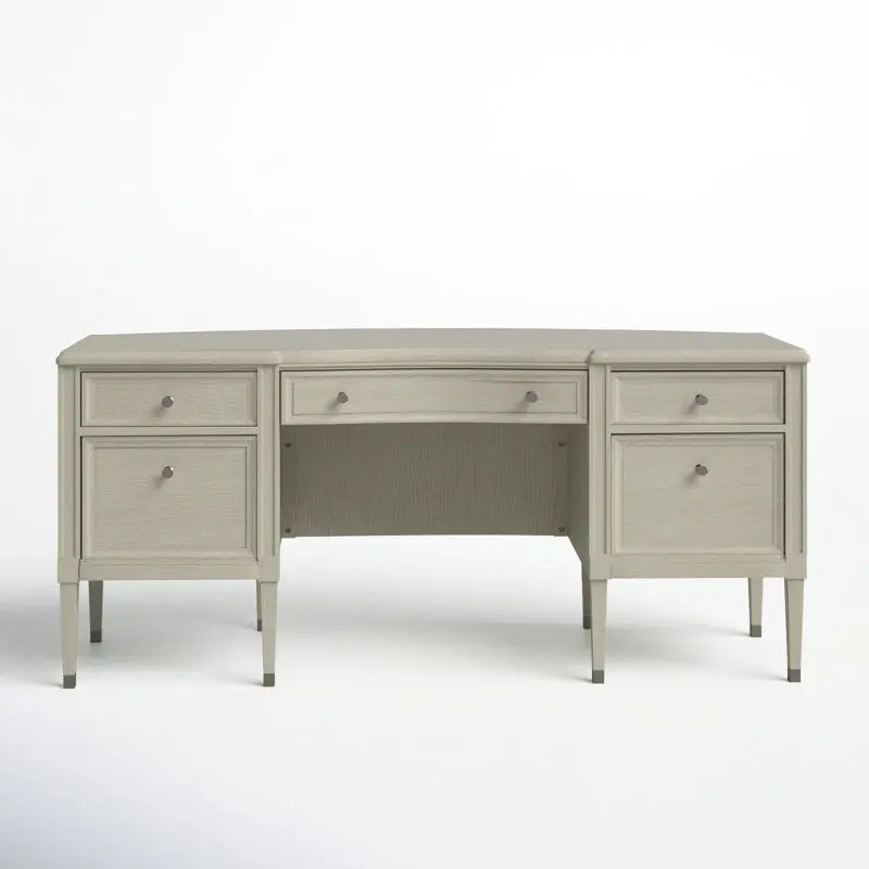 Beige solid wood executive desk with five drawers, tapered legs, and champagne finish on white background