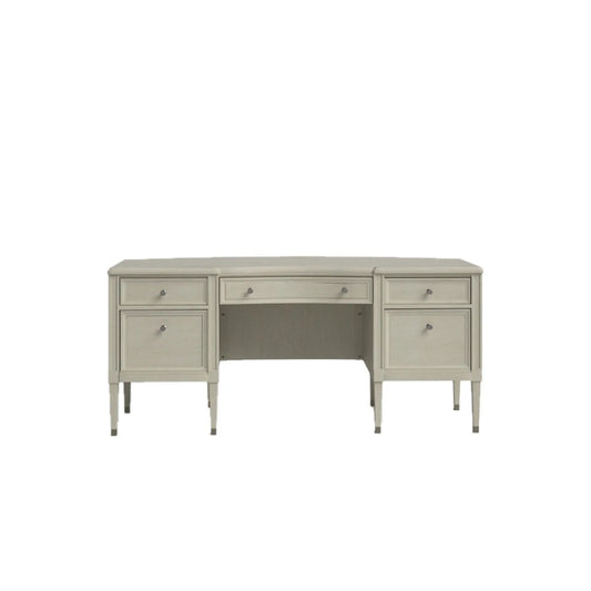 Beige wooden executive desk with five drawers and tapered legs on a white background