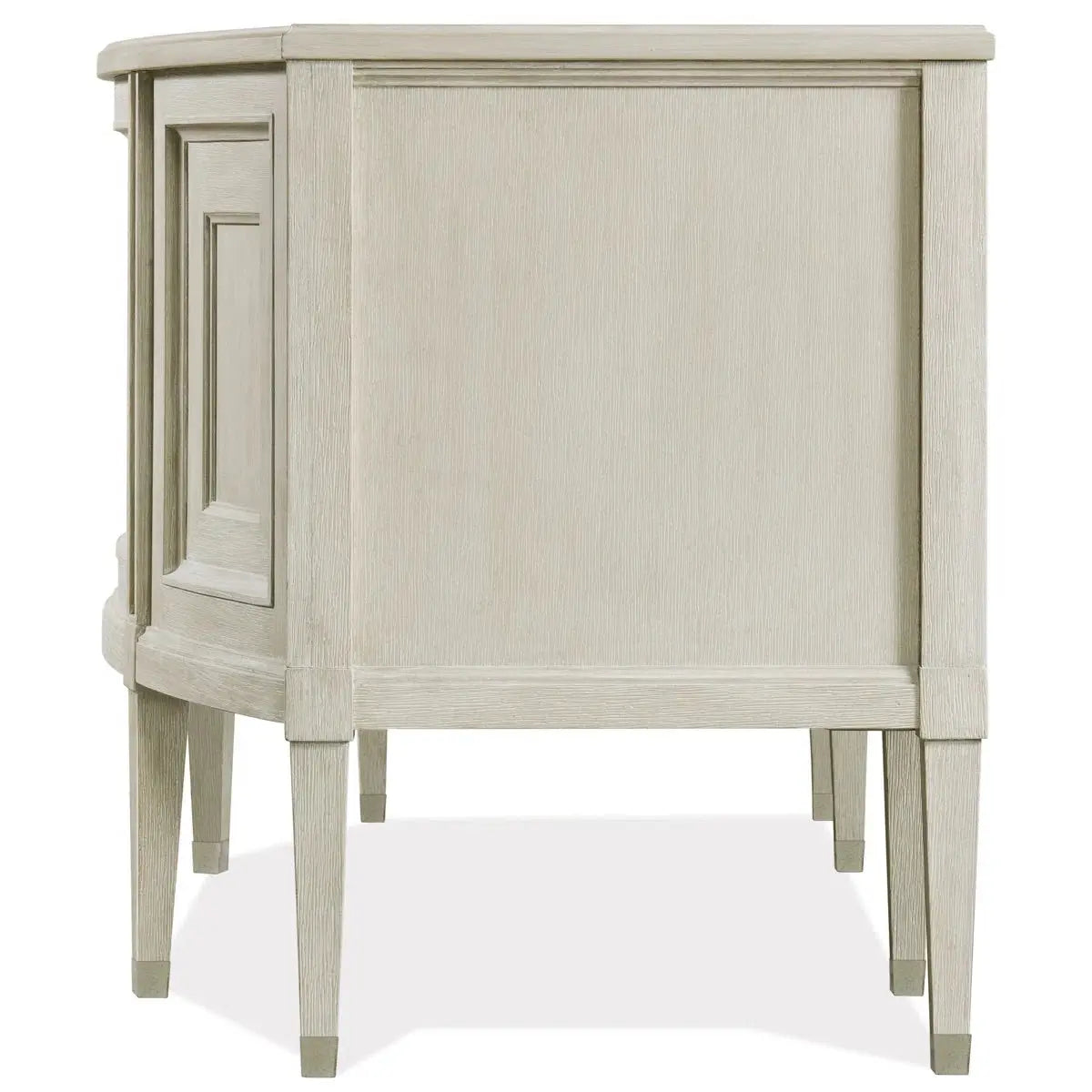 Side view of beige wooden executive desk with tapered legs and raised decorative paneling on the side