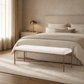 Load image into Gallery viewer, A modern fabric bench with a white cushion and a copper-toned metal frame sits at the foot of a bed in a softly lit neutral bedroom.
