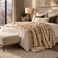 Load image into Gallery viewer, A cozy bedroom scene featuring a plush, chunky knit beige throw blanket draped over a bed with white bedding, set in a warm, modern mountain-view bedroom.
