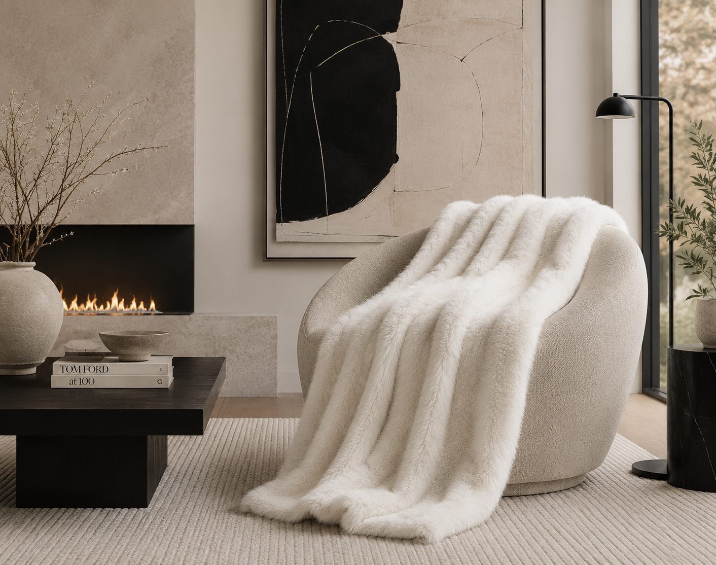 FAUX FUR THROW IVORY in living room on chair across from fireplace and coffee table that has books on it