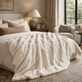 Load image into Gallery viewer, A plush cream faux fur throw blanket with a chunky textured, ribbed pattern draped over a bed in a beautifully styled, neutral-toned bedroom.

