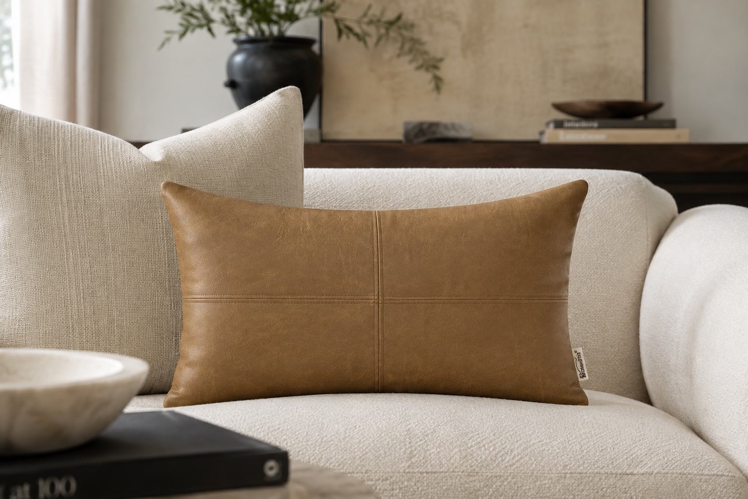 faux leather pillow on sofa in living room close up