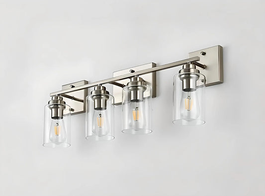 A modern House of Effy FOUR LIGHTS WALL VANITY LIGHT with four cylindrical glass shades and exposed filament bulbs on a metallic base, perfect for enhancing your morning routine upgrade with exceptional bathroom illumination.