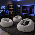 Load image into Gallery viewer, Three round beige fabric bean bag chairs arranged on a dark rug in a modern gaming room. One chair has a black pillow with a white video game controller graphic and the words 'LEVEL UP'.
