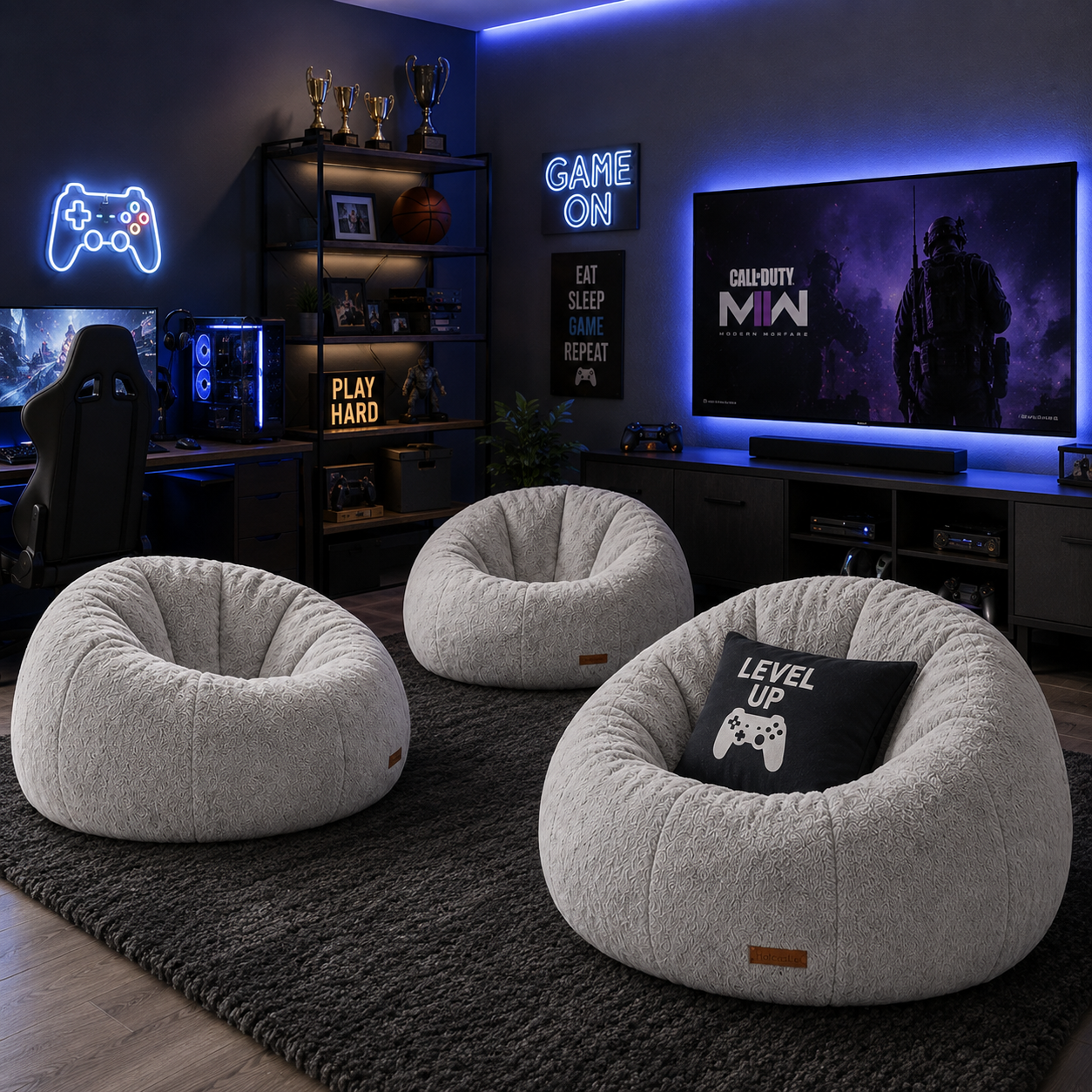 Three round beige fabric bean bag chairs arranged on a dark rug in a modern gaming room. One chair has a black pillow with a white video game controller graphic and the words 'LEVEL UP'.