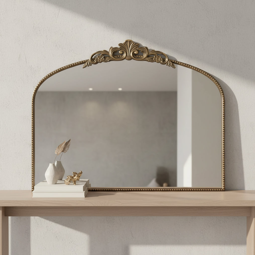 framed mirror in room on console table with books