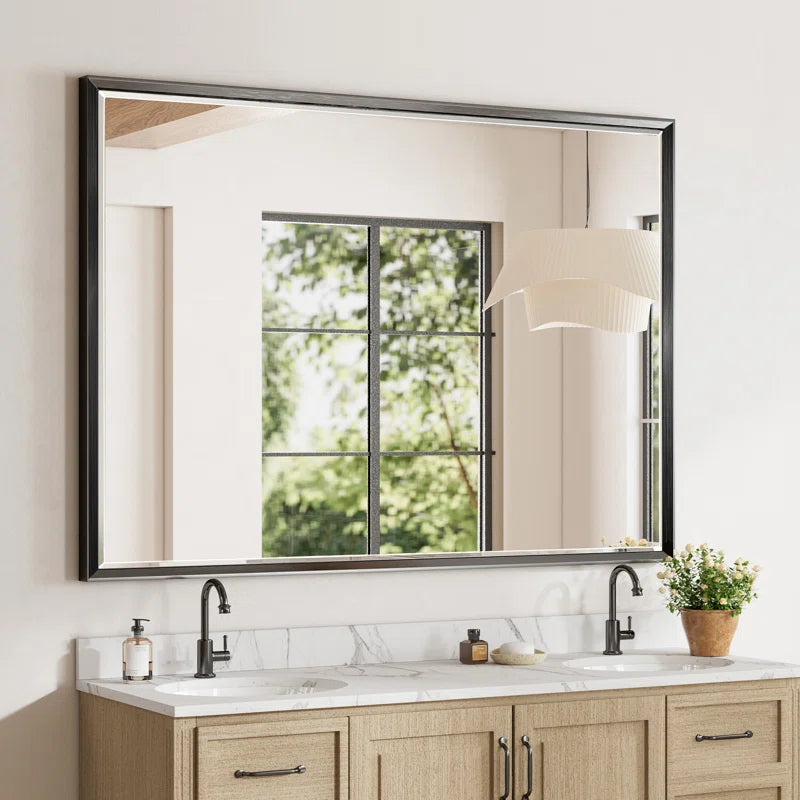 framed mirror on wall in bathroom