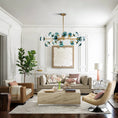 Load image into Gallery viewer, glass globe chandelier in living room above coffee table
